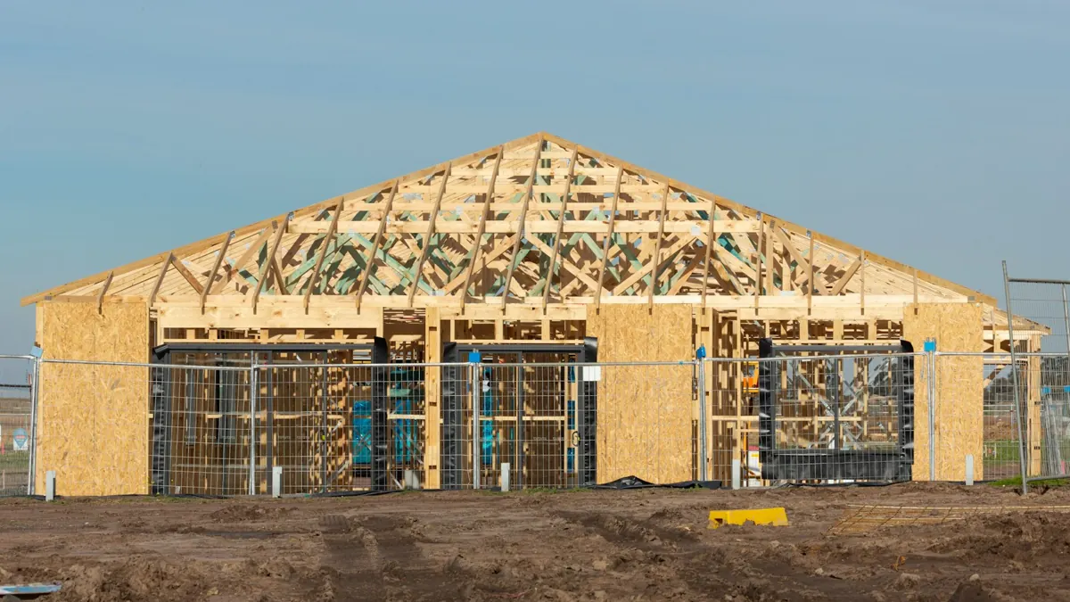 Timber house framing and roof trusses under construction