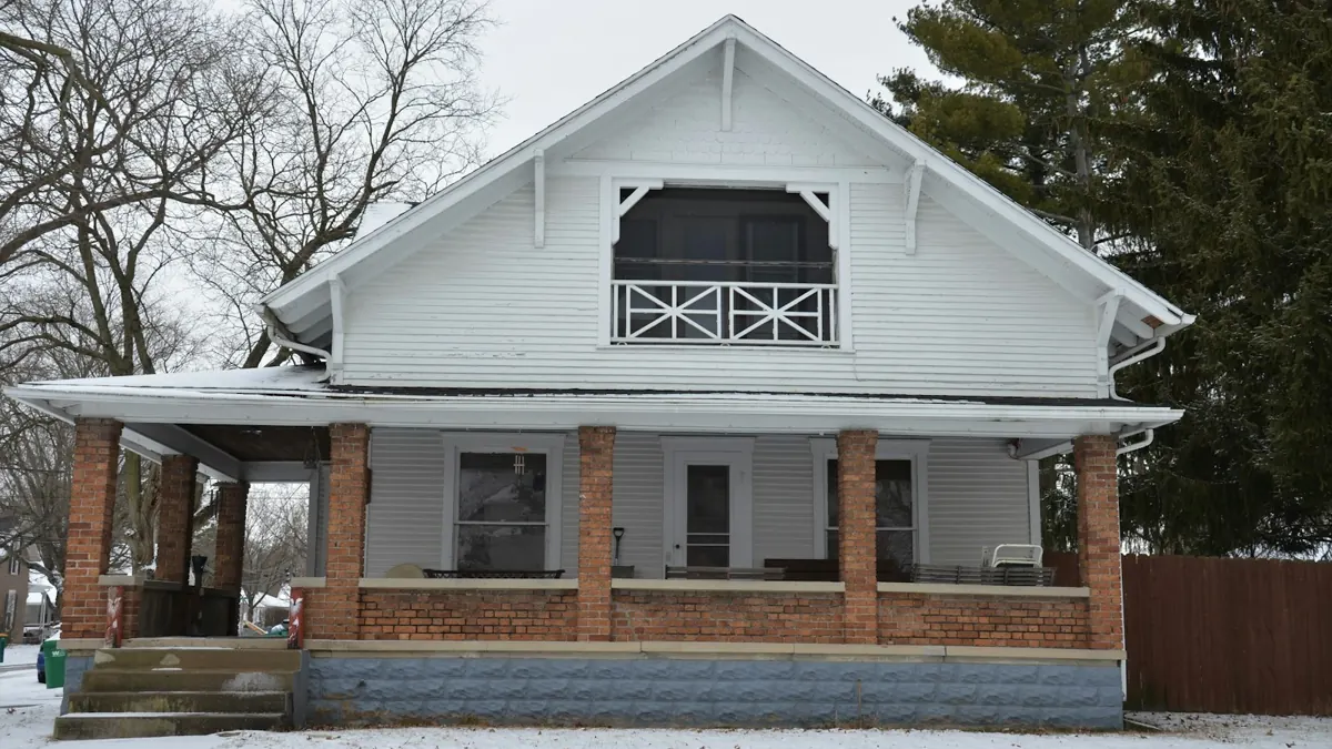 White house with a brick porch and screened upper porch